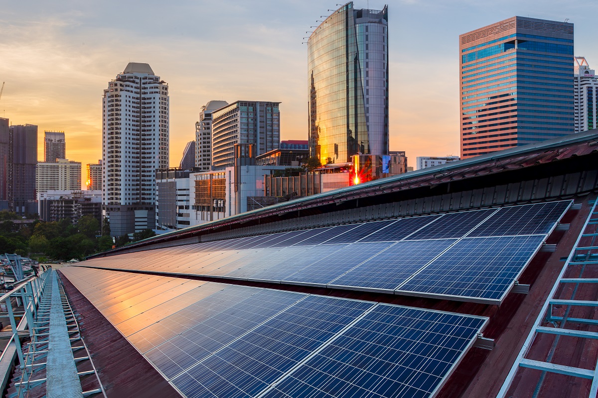 Solar Panel Photovoltaic installation on a Roof of factory, sunny blue sky background, alternative electricity source - Sustainable Resources Concept.