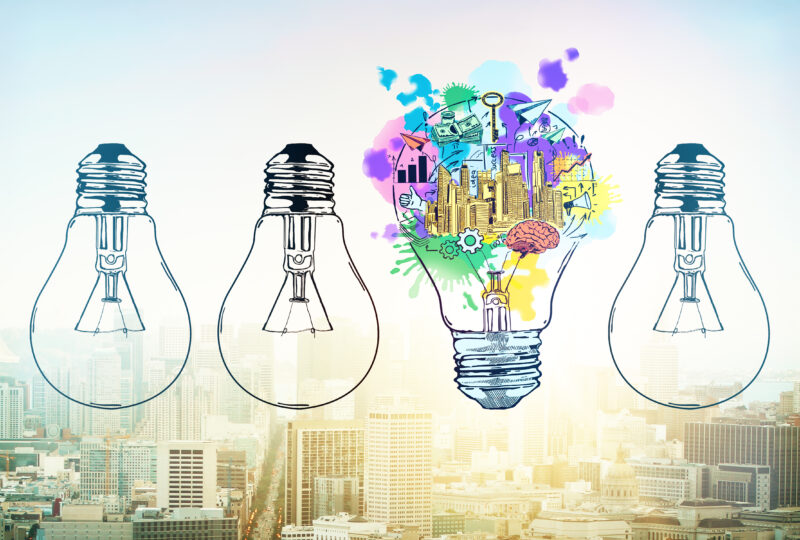 Abstract drawn lamps and business sketch on city background. Idea concept