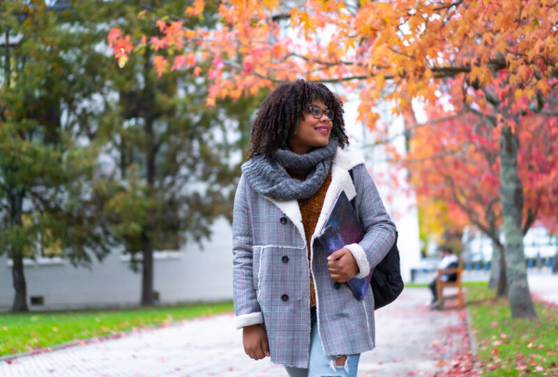 Black ethnic girl strolling in college college in fall back to school